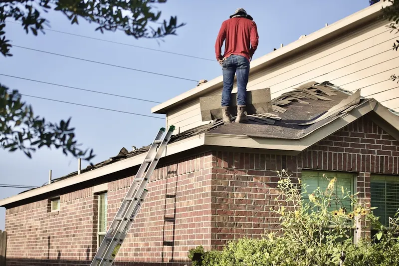 Professional roofer working on a residential roof in Poplar Estates